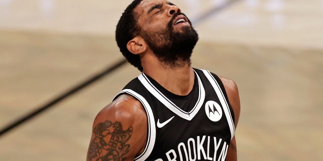 Brooklyn Nets guard Kyrie Irving reacts to missing a shot during the second half of the team's NBA basketball game against the Atlanta Hawks, Friday, Jan. 1, 2021, in New York. (AP Photo/Adam Hunger)