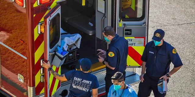 After administering him with oxygen, County of Los Angeles paramedics load a potential COVID-19 patient in the ambulance before transporting him to a hospital in Hawthorne, California on December 29, 2020. (Photo by APU GOMES/AFP via Getty Images)