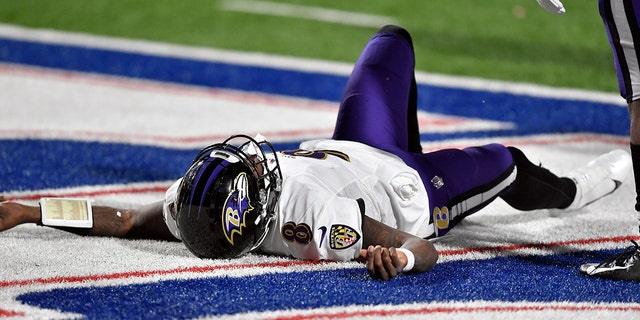 Baltimore Ravens quarterback Lamar Jackson (8) sits on the ground after being injured during the second half of an NFL Division football game against the Buffalo Bills on Saturday, Jan. 16, 2021, at Orchard Park, NY Jackson left the game after his injury.  (AP Photo / Adrian Kraus)