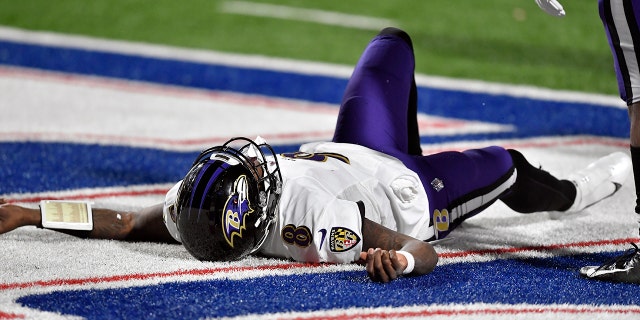 Baltimore Ravens quarterback Lamar Jackson (8) sits on the ground after being injured during the second half of an NFL Division football game against the Buffalo Bills on Saturday, Jan. 16, 2021, at Orchard Park, NY Jackson left the game after his injury.  (AP Photo / Adrian Kraus)