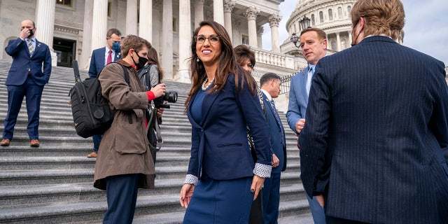 Rep. Lauren Boebert, R-Colo., center, smiles after joining other freshman Republican House members for a group photo at the Capitol in Washington, Jan. 4, 2021. (AP Photo/J. Scott Applewhite)
