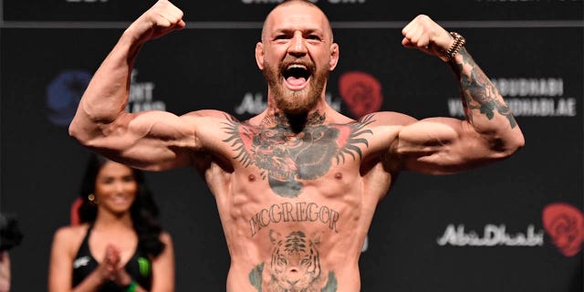 Conor McGregor of Ireland poses on the scale during the UFC 257 weigh-in at Etihad Arena on UFC Fight Island, Jan. 22, 2021, in Abu Dhabi, United Arab Emirates.