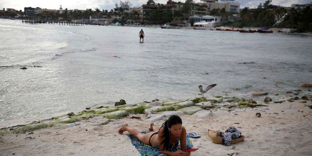 A tourist relaxes on the shore of Mamitas beach amid the new coronavirus pandemic in Playa del Carmen. (AP Photo/Emilio Espejel)