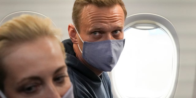 Alexei Navalny and his wife, Yulia, sit in the plane prior to their flight to Moscow in the Airport Berlin Brandenburg (BER) in Schoenefeld, near Berlin, Germany, Sunday, Jan. 17, 2021.