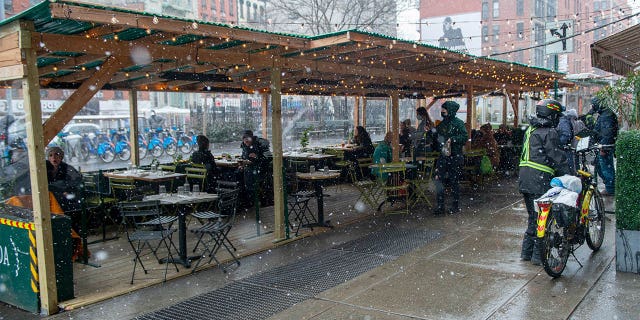 Customers dine outdoors at Jack's Wife Freda's enclosed outdoor dining structure during a snowstorm amid the coronavirus pandemic in SoHo on Jan. 26, 2021, in New York City. The pandemic continues to burden restaurants and bars as businesses struggle to thrive with evolving government restrictions and social distancing plans made harder by inclement weather. (Alexi Rosenfeld/Getty Images)