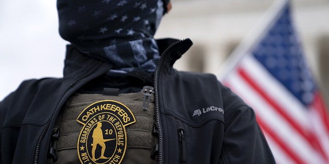 A demonstrator wears an Oath Keepers anti-government organization badge on a protective vest during a protest outside the Supreme Court in Washington, D.C., U.S., on Tuesday, Jan. 5, 2021. Photographer: Stefani Reynolds/Bloomberg via Getty Images
