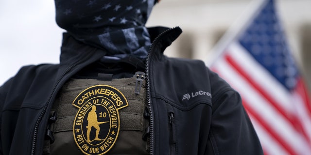 A demonstrator wears an Oath Keepers anti-government organization badge on a protective vest during a protest outside the Supreme Court in Washington, D.C., U.S., on Tuesday, Jan. 5, 2021. Photographer: Stefani Reynolds/Bloomberg via Getty Images