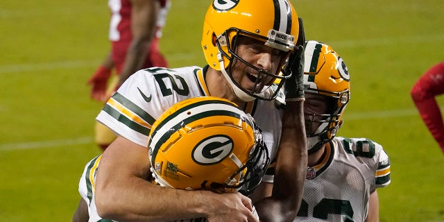 Green Bay Packers wide receiver Marquez Valdes-Scantling, bottom left, and quarterback Aaron Rodgers (12) celebrate after connecting on a touchdown pass against the San Francisco 49ers in Santa Clara, Calif., Nov. 5, 2020.