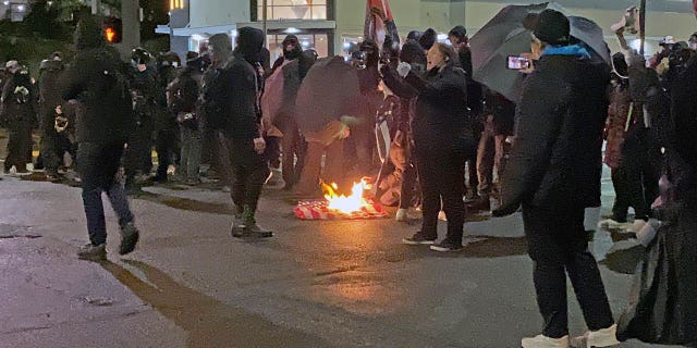 After Tacoma Police set up a police line, the Antifa activists stopped their march to set fire to an American flag.