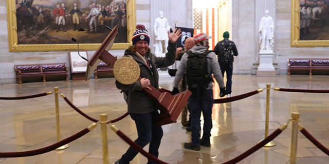 The man seen carrying the U.S. House lectern has reportedly been identified on social media. (Photo by Win McNamee/Getty Images)