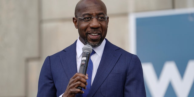 Democratic U.S. Senate candidate Raphael Warnock speaks to labor organizers and the media outside a labor union's offices in Atlanta, Georgia, Jan. 5, 2021. REUTERS/Elijah Nouvelage