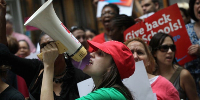 Sarah Chambers, a special education teacher, leads other Chicago school teachers in a chant during a protest June 22, 2011, in Chicago, Ill. (Scott Olson/Getty Images)