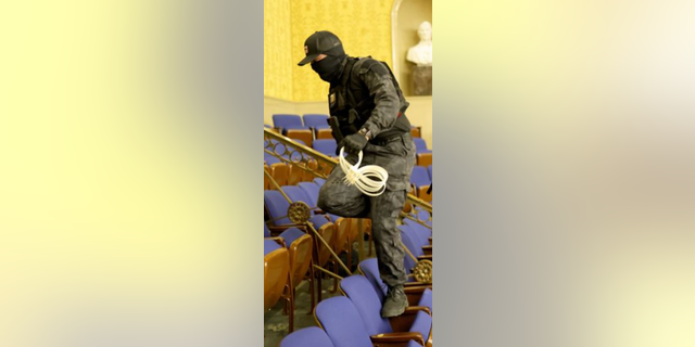 Police say this photo depicts Eric Munchel carrying "flex cuffs (plastic restraints)" that are "used by Law-enforcement to restrain and/or detain subjects" inside the Senate chamber.
