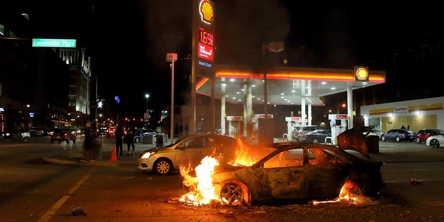 A car burns at the corner of Martin Luther King Boulevard and Tucker Boulevard on Tuesday, June 2, 2020. 