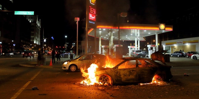 A car burns at the corner of Martin Luther King Boulevard and Tucker Boulevard on Tuesday, June 2, 2020.
