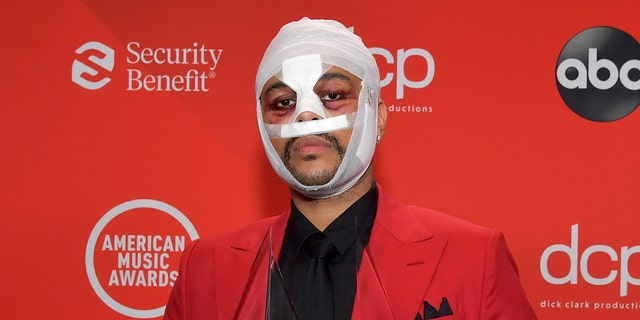 The Weeknd has previously appeared with facial bandages at the American Music Awards, but it's unclear if they are related to his new appearance.  (Getty Images)