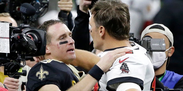 New Orleans Saints quarterback Drew Brees, center left, chats with Tampa Bay Buccaneers quarterback Tom Brady after an NFL Division Round playoff football game on Sunday 17th January 2021, in New Orleans.  The Buccaneers won 30-20.  (AP Photo / Dill Butch)