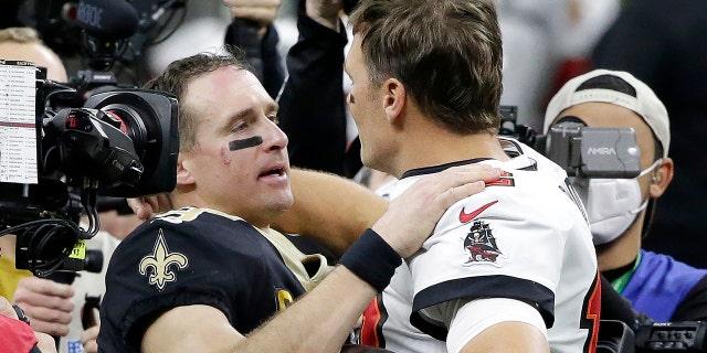 New Orleans Saints quarterback Drew Brees, center left, chats with Tampa Bay Buccaneers quarterback Tom Brady after an NFL Division Round playoff football game on Sunday 17th January 2021, in New Orleans.  The Buccaneers won 30-20.  (AP Photo / Dill Butch)