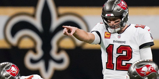 Tampa Bay Buccaneers quarterback Tom Brady (12) signals at the line of scrimmage against the New Orleans Saints during the first half of an NFL divisional round playoff football game, Sunday, Jan. 17, 2021, in New Orleans.