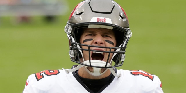 Tom Brady yells as he takes to the field before the NFC championship game against the Packers in Green Bay, Wisconsin, Jan. 24, 2021.