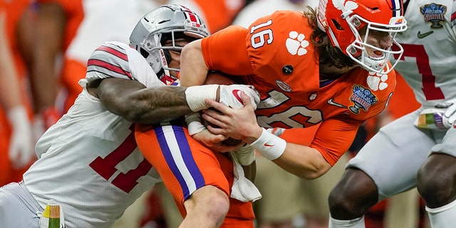 Clemson quarterback Trevor Lawrence is tackled by Ohio State defensive end Tyreke Smith during the second half of the Sugar Bowl NCAA college football game Friday, Jan. 1, 2021, in New Orleans. (Associated Press)