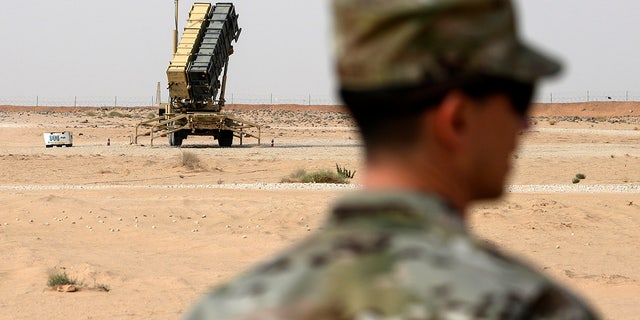 FILE - In this Feb. 20, 2020 file photo, a member of the U.S. Air Force stands near a Patriot missile battery at the Prince Sultan Air Base in al-Kharj, Saudi Arabia. (Andrew Caballero-Reynolds/Pool via AP, File)