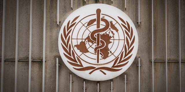 The World Health Organization's symbol on the side of a building.