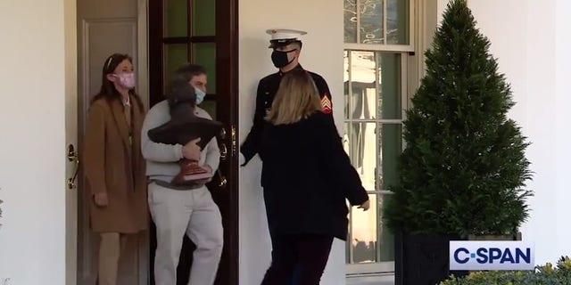 A bust of Abe Lincoln is carried out of the White House grounds. (C-SPAN)