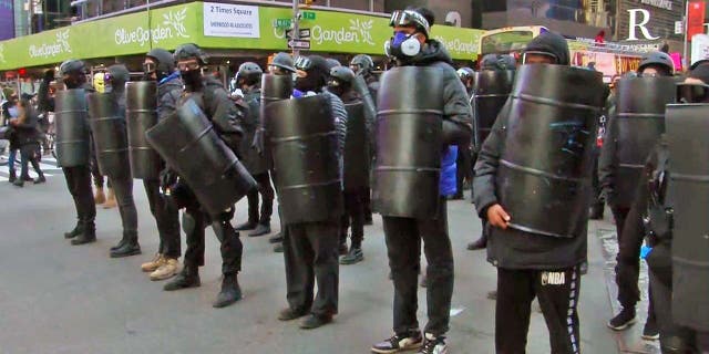 Antifa protesters carrying shields and wearing helmets marched through New York on Sunday.