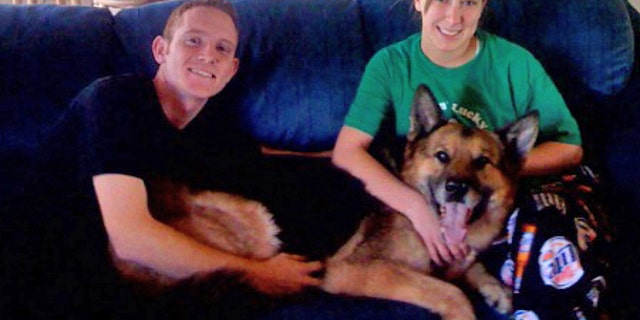 EIELSON AIR FORCE BASE, Alaska--Staff Sgt. Timothy and Airman 1st Class Ashli McEntee take a break with newly-adopted, former military working dog, Sorbon A333 in mid-January. Sergeant McEntee was Sorbon's mwd handler while stationed at Eielson; he and his wife adopted Sorbon Jan. 11. (courtesy photo)