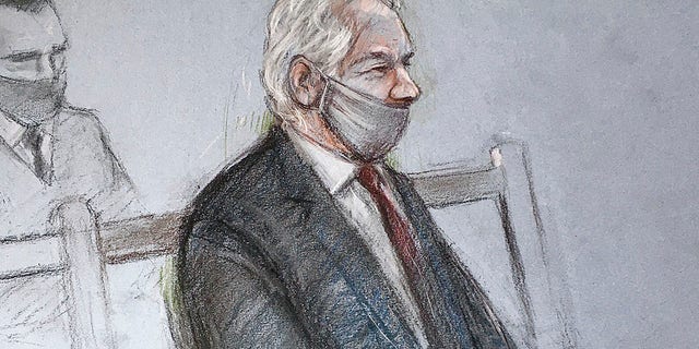 This is a court artist sketch by Elizabeth Cook of Julian Assange appearing at the Old Bailey in London for the ruling in his extradition case in London on Monday. (AP)