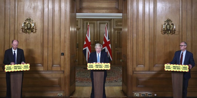 Britain's Prime Minister Boris Johnson, flanked by Chief Medical Officer for England Chris Whitty, left, and Chief Scientific Adviser Sir Patrick Vallance, speaks during a news conference about the coronavirus pandemic on Tuesday. (AP)