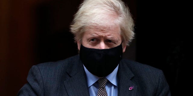 Johnson leaves 10 Downing Street for the House of Commons for the weekly Prime Ministers Questions in London, Wednesday, Jan. 27, 2021. (AP Photo/Alastair Grant)