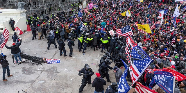 Rioters and police clash outside the U.S. Capitol in Washington, January 6, 2021 (Getty Images)