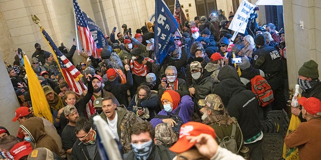 WASHINGTON, DC - JANUARY 06: Protesters supporting U.S. President Donald Trump gather near the east front door of the U.S. Capitol after groups breached the building's security on January 06, 2021 in Washington, DC. (Photo by Win McNamee/Getty Images)