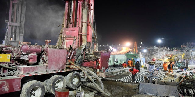 Rescuers drill a new channel at the site of a gold mine that exploded in Qixia City, China, on Monday. (AP/Xinhua)