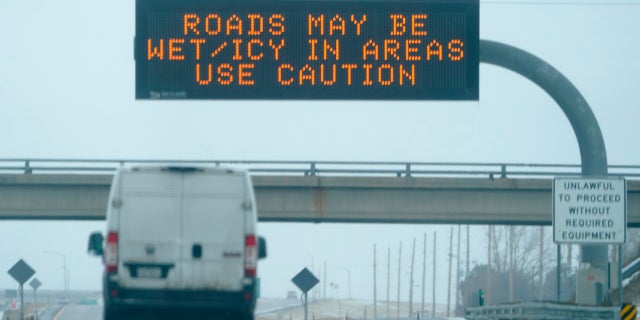 An electronic road signs warns motorists headed eastbound on Interstate 70 about difficult driving conditions as a winter storm sweeps over the intermountain West on Tuesday in Aurora, Colo. (AP)