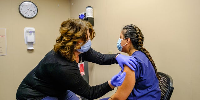 BLOOMINGTON, INDIANA, STATI UNITI - 2020/12/18: Zaira Hernandez, front line Healthcare worker is vaccinated with the Pfizer covid-19 vaccine by Amy Meek at IU Health Bloomington. (Photo by Jeremy Hogan/SOPA Images/LightRocket via Getty Images)