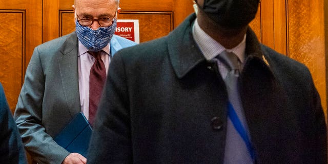 Senate Majority Leader Chuck Schumer of N.Y, takes the elevator in the U.S. Capitol, Friday, Jan. 22, 2021, in Washington. (AP Photo/Manuel Balce Ceneta)