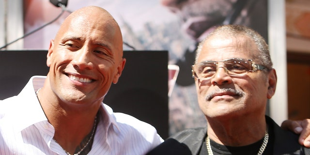 Dwayne "The rock" Johnson, left, said he had a "incredibly complicated" relationship with his father, WWE star Rocky Johnson.  (Photo by Michael Tran / FilmMagic)