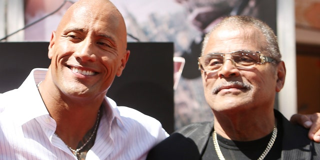 Dwayne "The rock" Johnson, left, said he had a "incredibly complicated" relationship with his father, WWE star Rocky Johnson.  (Photo by Michael Tran / FilmMagic)