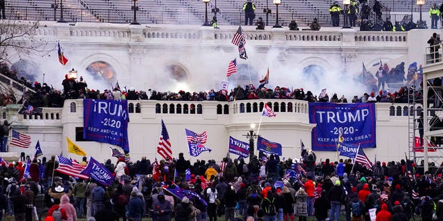 Violent rioters, loyal to former President Donald Trump, storm the Capitol in Washington. (AP Photo/John Minchillo, File)