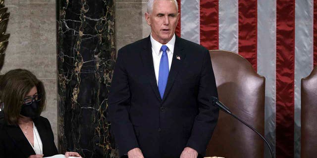 Vice President Mike Pence listens after reading the final certification of Electoral College votes cast in November's presidential election during a joint session of Congress after working through the night, at the Capitol in Washington, Thursday, Jan. 7, 2021. Violent protesters loyal to President Donald Trump stormed the Capitol Wednesday, disrupting the process. (AP Photo/J. Scott Applewhite, Pool)