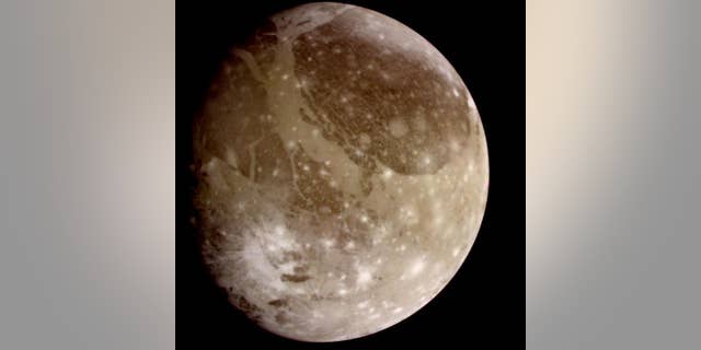Natural color view of Ganymede from the Galileo spacecraft during its first encounter with the satellite. North is to the top of the picture and the sun illuminates the surface from the right. The dark areas are the older, more heavily cratered regions and the light areas are younger, tectonically deformed regions. (NASA/JPL)