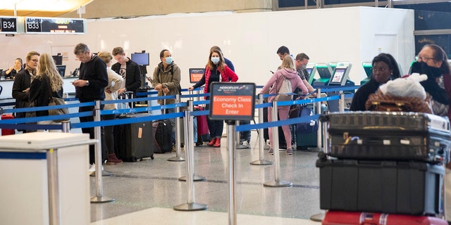 (file photo) Los Angeles, California: March 12, 2020- Passengers at LAX Airport waiting in line for check-in.
