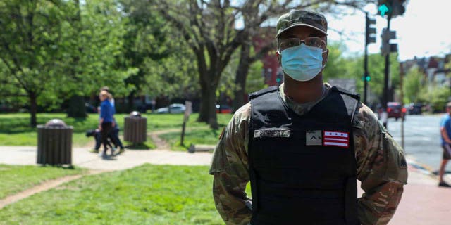 D.C. National Guardsman wears a black identification vest instead of a camouflage option.