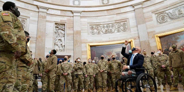 Rep. Brian Mast, R-Fla., gives troops a tour in the Rotunda on Capitol Hill in Washington, Wednesday, Jan. 13, 2021. (AP Photo/Susan Walsh)