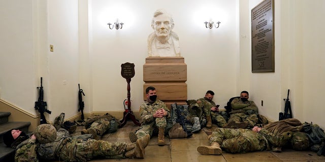 National Guard members sleep before Democrats begin debating one article of impeachment against U.S. President Donald Trump at the U.S. Capitol, on Jan. 13, 2021. (Reuters/Joshua Roberts)