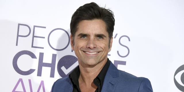 John Stamos claims to have been exposed to COVID-19 three times so far due to his acting work.  (Jordan Strauss / Invision / AP)
