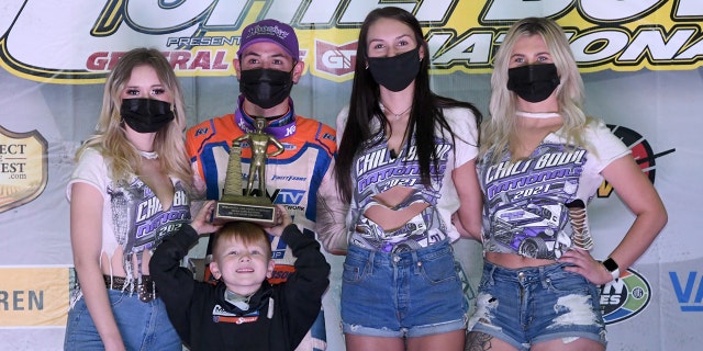 Larson was presented with the Golden Driller trophy by his son, Owen.